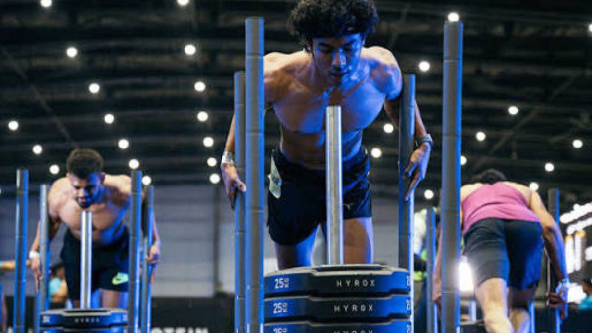 Athletes performing a HYROX workout on a competition course
