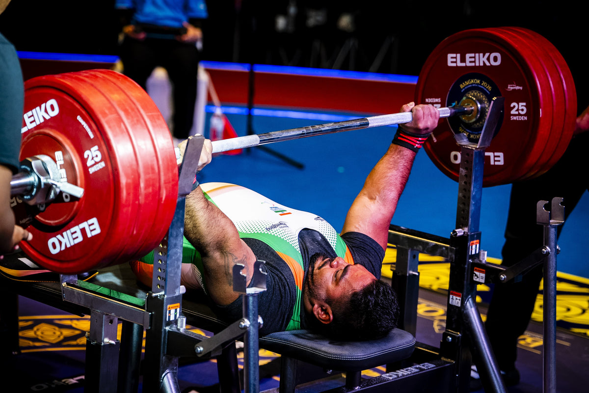 Powerlifting India record attempt during a competitive bench press with a heavily loaded barbell.
