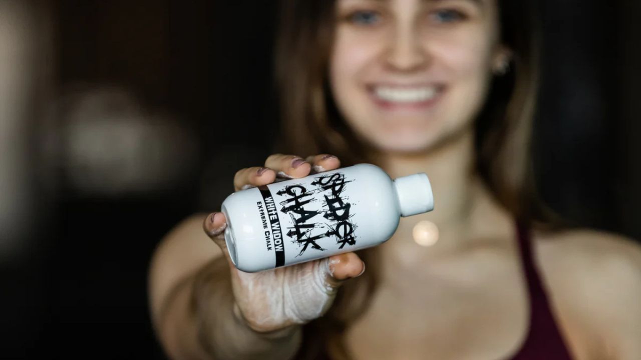 athlete showing white widow liquid chalk bottle